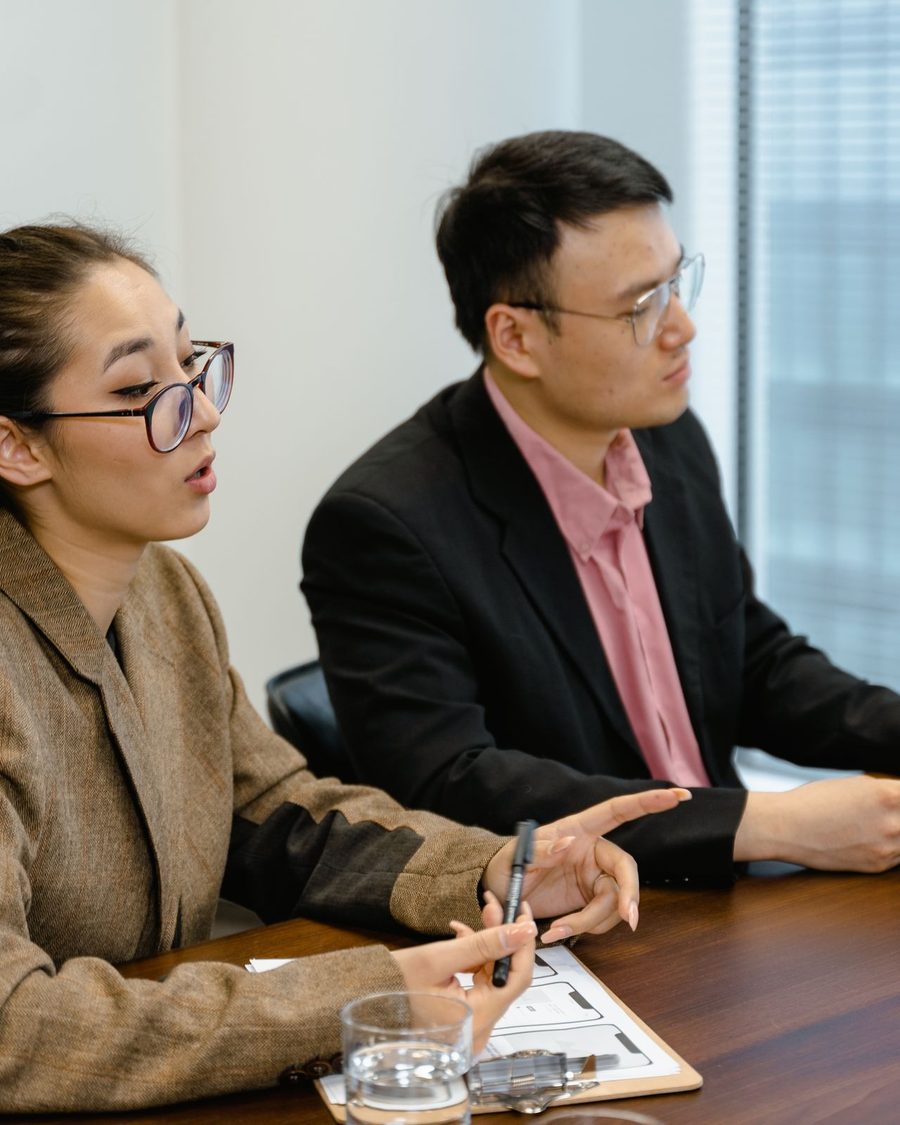 Two executives in conversation in a boardroom